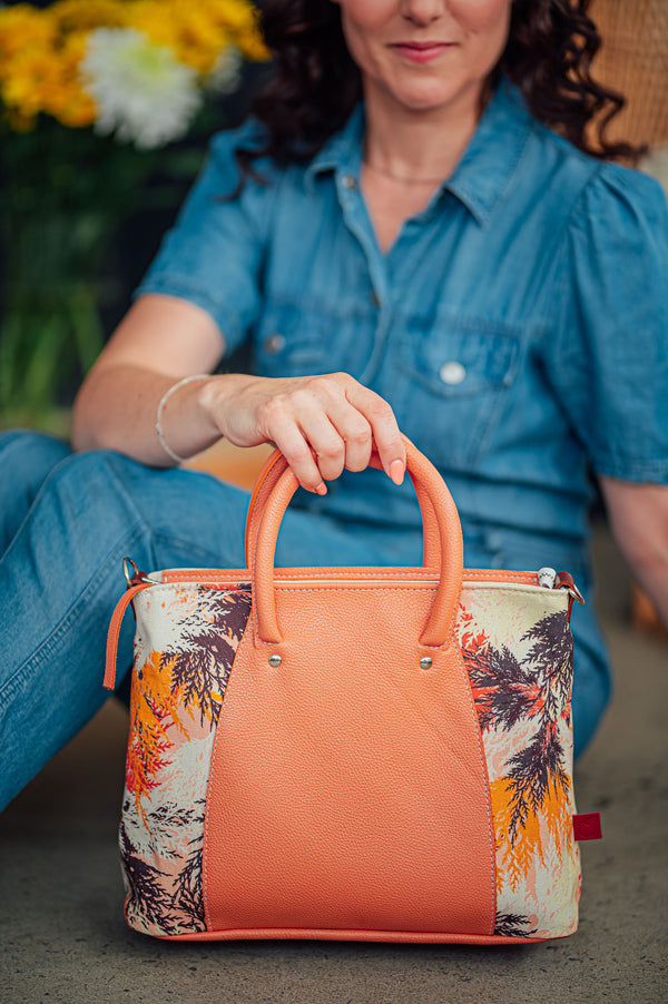 Sac à main zippé en cuir peach fuzz et imprimé cèdre orange et violet. Fait à la main à Montréal